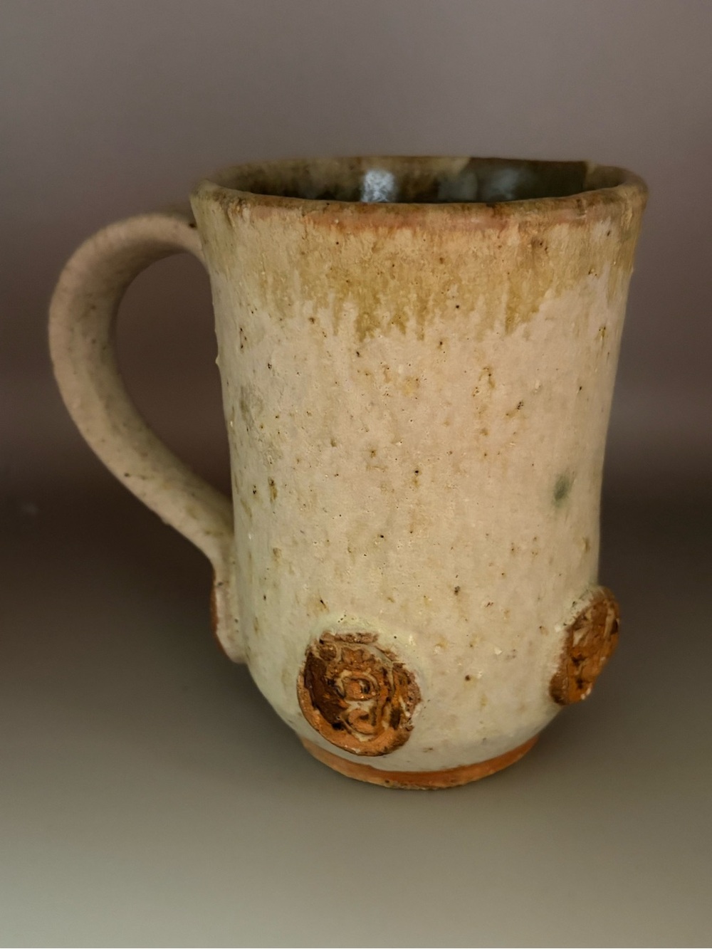 Source Unknown Cream and Tan Ceramic Mug with Decorative Accents